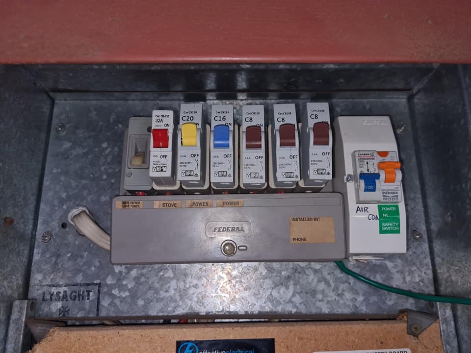 A switchboard with labelled circuit breakers wired into a metal enclosure